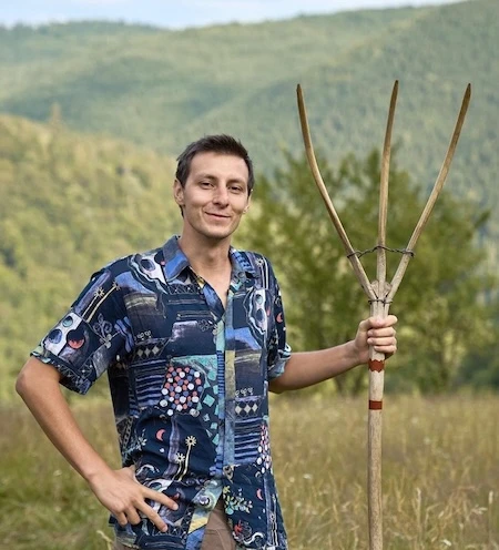 Image of me holding an old wood fork with the forest background