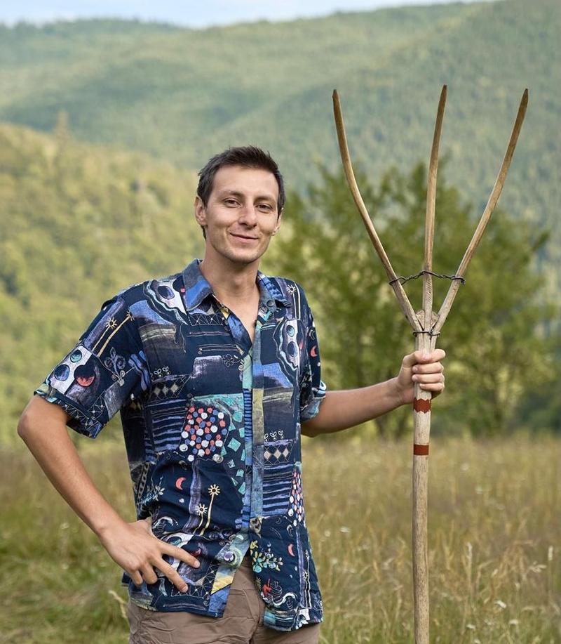 Image of me holding an old wood fork with the forest background